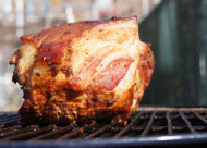 barbecued pork shoulder on a gas grill